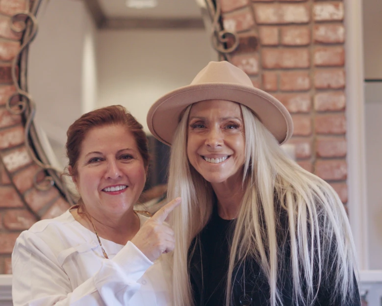 Patient and dentist smiling together after clear aligners treatment at a San Diego dental clinic.