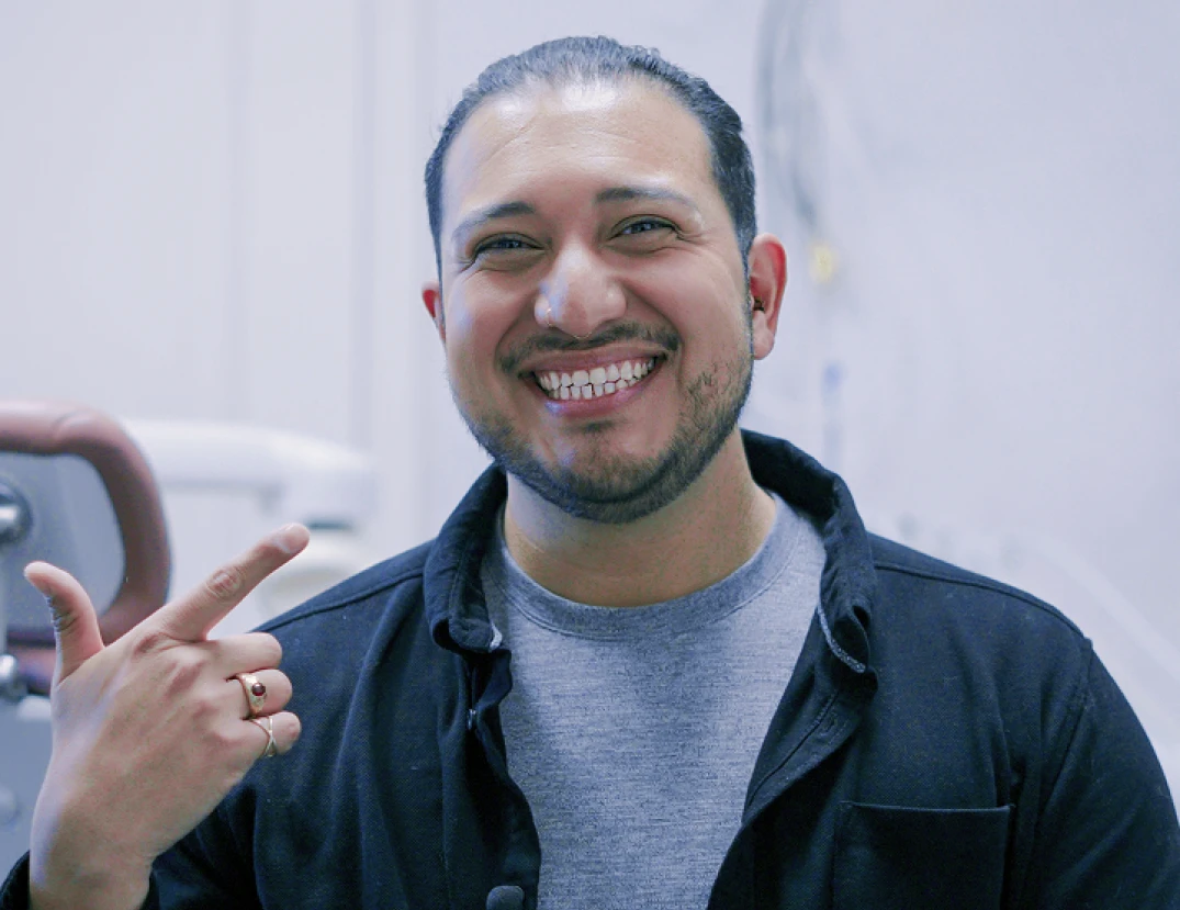 Dental staff member and patient smiling together at a San Diego dental clinic.