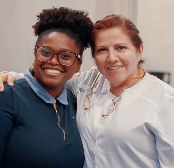 Dental staff member and patient smiling together at a San Diego dental clinic.