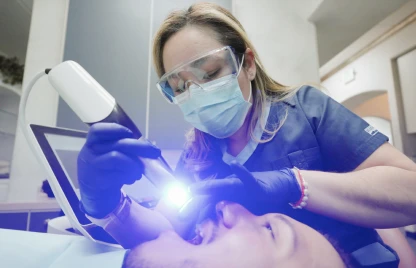 Dentist performing a root canal procedure using advanced dental technology.