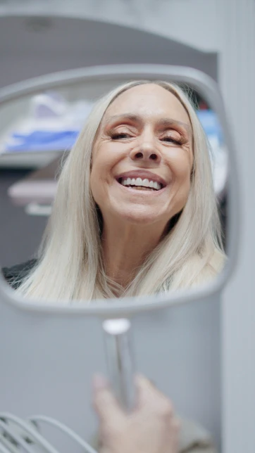 Smiling woman during a dental checkup at a modern San Diego dental clinic